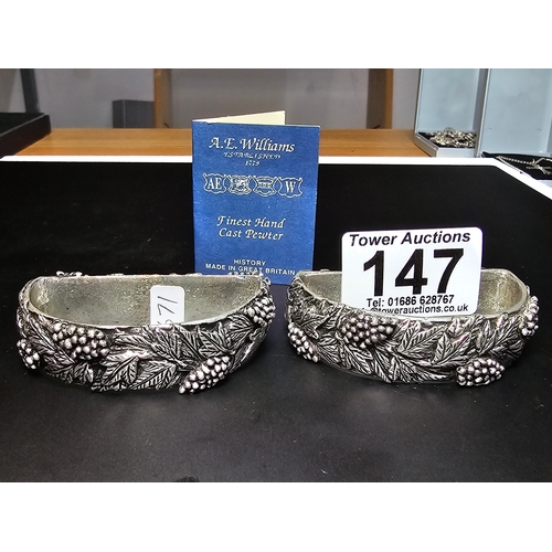 147 - A hallmarked silver napkin ring along with a pair of ornate hand cast pewter napkin rings with a gra... 