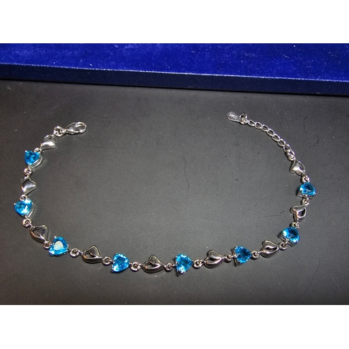 149 - A pretty 925 silver bracelet inset with 8x blue faceted crystal stones. The bracelet has a length of... 