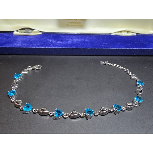 149 - A pretty 925 silver bracelet inset with 8x blue faceted crystal stones. The bracelet has a length of... 