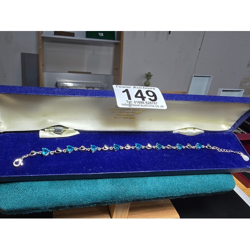 149 - A pretty 925 silver bracelet inset with 8x blue faceted crystal stones. The bracelet has a length of... 