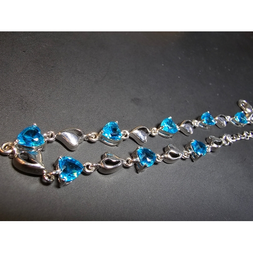 149 - A pretty 925 silver bracelet inset with 8x blue faceted crystal stones. The bracelet has a length of... 