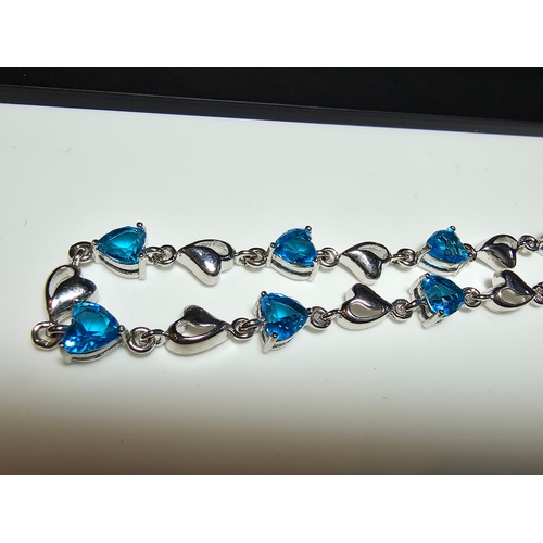 149 - A pretty 925 silver bracelet inset with 8x blue faceted crystal stones. The bracelet has a length of... 