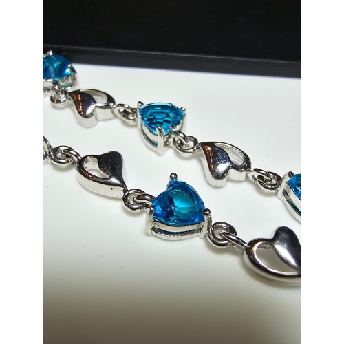 149 - A pretty 925 silver bracelet inset with 8x blue faceted crystal stones. The bracelet has a length of... 