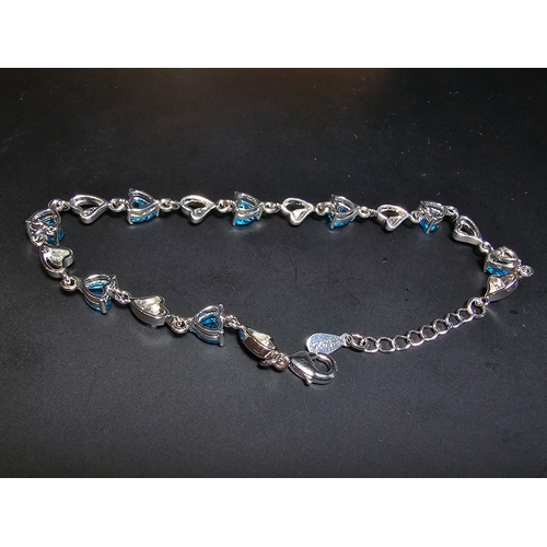 149 - A pretty 925 silver bracelet inset with 8x blue faceted crystal stones. The bracelet has a length of... 