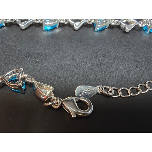 149 - A pretty 925 silver bracelet inset with 8x blue faceted crystal stones. The bracelet has a length of... 