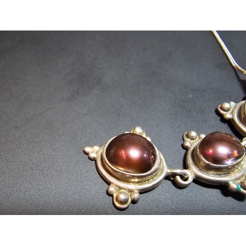 151 - A stunning 925 silver drop pendant inset with 3x natural brown pearls set on an 18