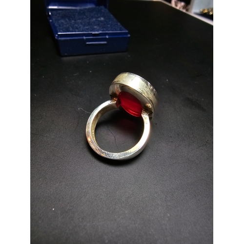 160 - 925 Silver chunky ring inset with a red glass panel, in good order, size L, complete with presentati... 