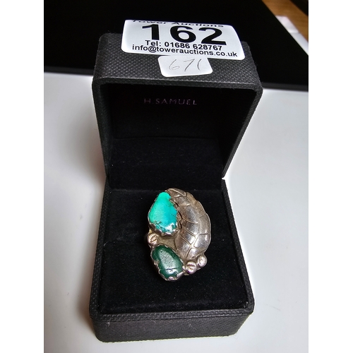 162 - A Good 925 Silver ring with a leaf and stone design inset with a large turquoise stone and jade ston... 