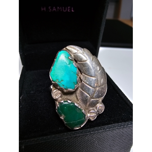 162 - A Good 925 Silver ring with a leaf and stone design inset with a large turquoise stone and jade ston... 