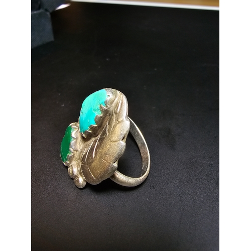 162 - A Good 925 Silver ring with a leaf and stone design inset with a large turquoise stone and jade ston... 