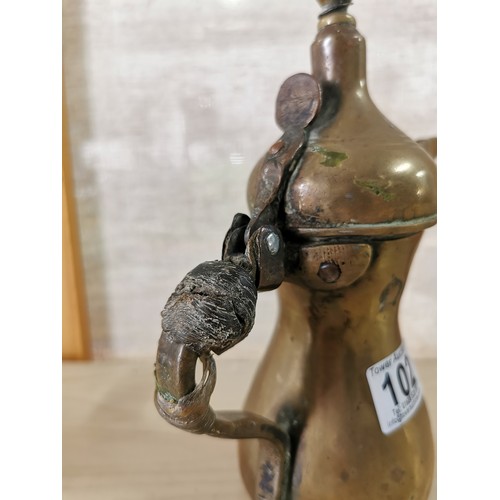 102 - Rare antique Middle Eastern Arabic brass Dallah coffee pot, animal hide can still be seen on the han... 