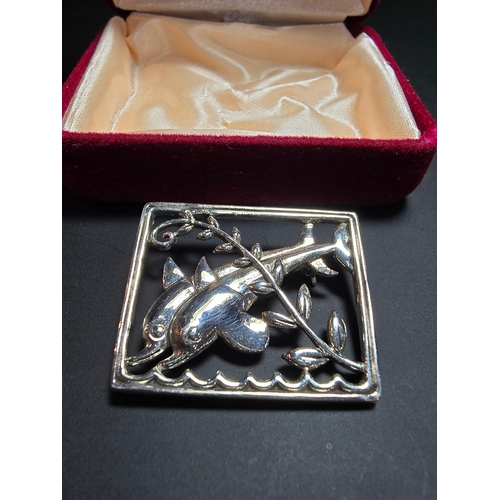 166 - An as new unused Danish Sterling Silver Brooch with a dolphin design, marked Sterling Denmark to the... 