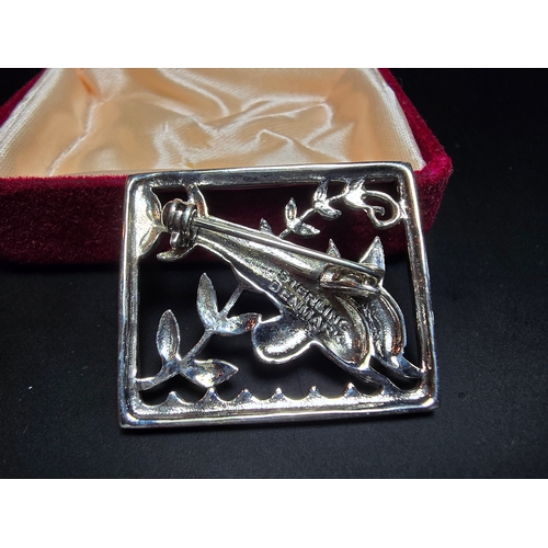 166 - An as new unused Danish Sterling Silver Brooch with a dolphin design, marked Sterling Denmark to the... 