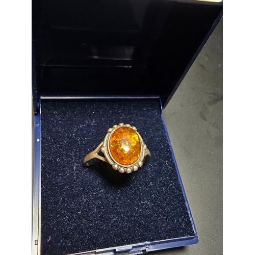 174 - Good vintage 925 Silver ring inset with a large natural amber stone, size N, in good clean condition... 