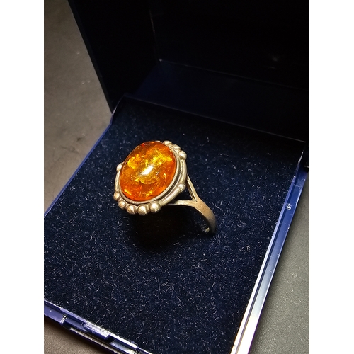 174 - Good vintage 925 Silver ring inset with a large natural amber stone, size N, in good clean condition... 