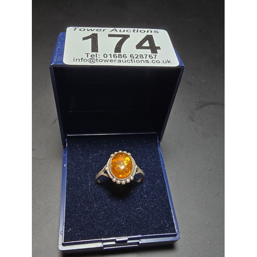 174 - Good vintage 925 Silver ring inset with a large natural amber stone, size N, in good clean condition... 