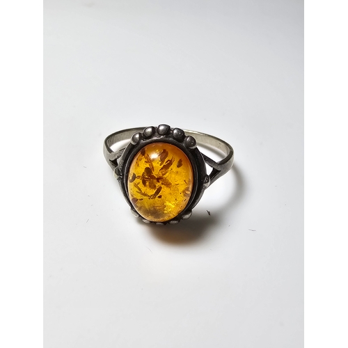 174 - Good vintage 925 Silver ring inset with a large natural amber stone, size N, in good clean condition... 