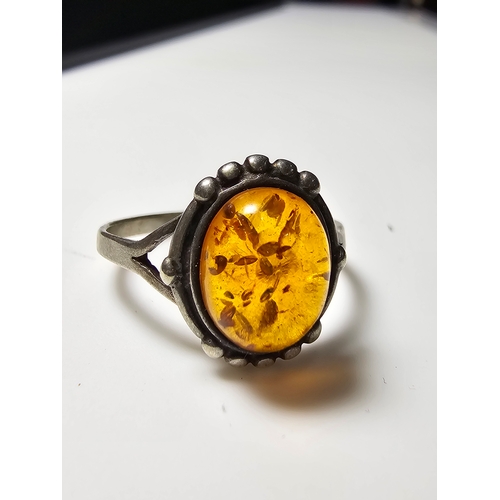 174 - Good vintage 925 Silver ring inset with a large natural amber stone, size N, in good clean condition... 