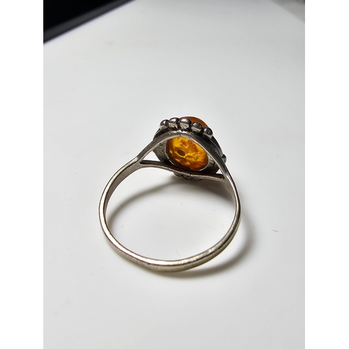 174 - Good vintage 925 Silver ring inset with a large natural amber stone, size N, in good clean condition... 