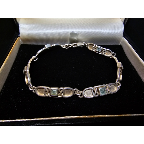 176 - A good 925 silver panel bracelet by Rennie Mackintosh collection, inset with blie topaz stones, in g... 