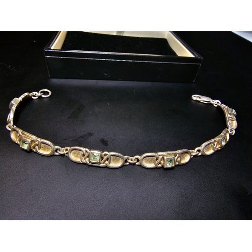 176 - A good 925 silver panel bracelet by Rennie Mackintosh collection, inset with blie topaz stones, in g... 