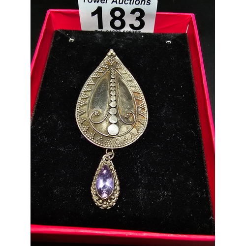 183 - A good quality 925 silver large drop pendant with a handworked intricate design, inset with a natura... 