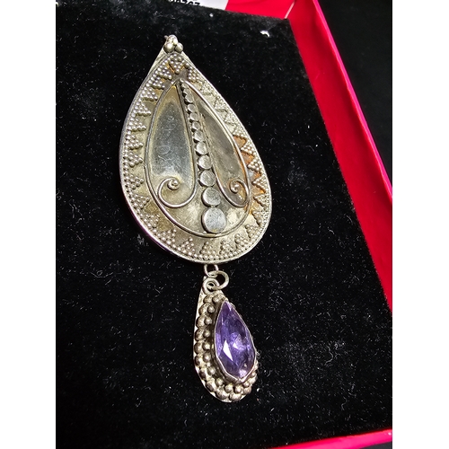 183 - A good quality 925 silver large drop pendant with a handworked intricate design, inset with a natura... 