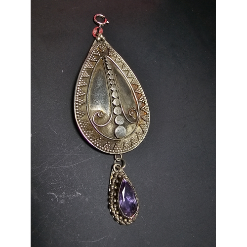 183 - A good quality 925 silver large drop pendant with a handworked intricate design, inset with a natura... 