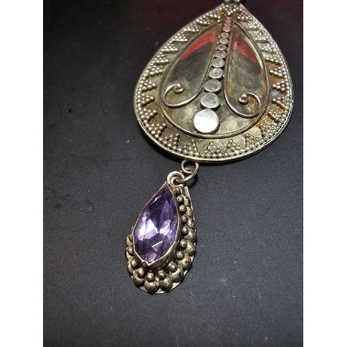 183 - A good quality 925 silver large drop pendant with a handworked intricate design, inset with a natura... 