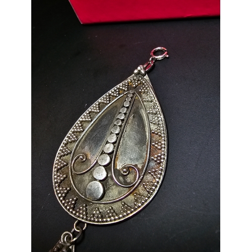 183 - A good quality 925 silver large drop pendant with a handworked intricate design, inset with a natura... 