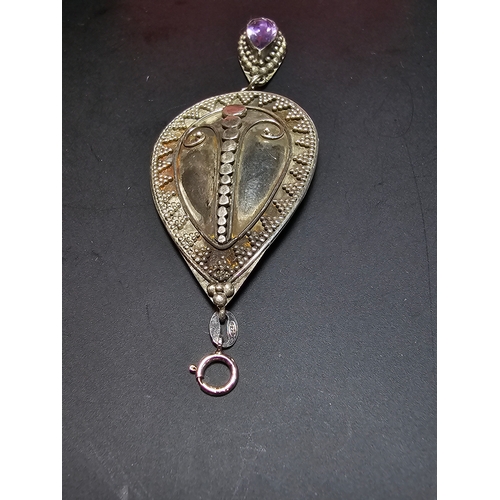 183 - A good quality 925 silver large drop pendant with a handworked intricate design, inset with a natura... 