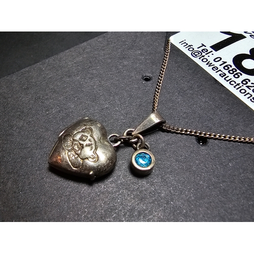 186 - 925 Silver locket pendant with a faceted blue cz crystal stone having a teddy design, set on a 18