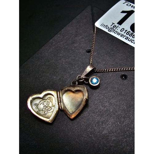 186 - 925 Silver locket pendant with a faceted blue cz crystal stone having a teddy design, set on a 18