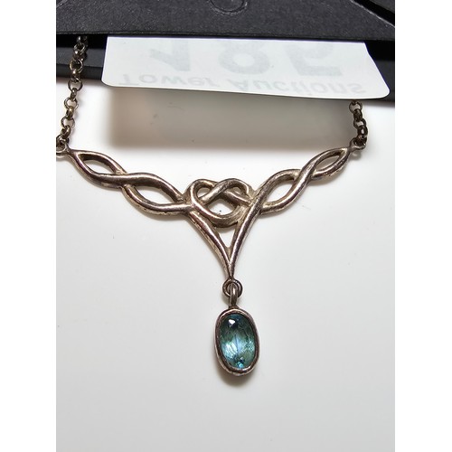 185 - 925 Silver pendant inset with a faceted blue topaz stone, set on a 18