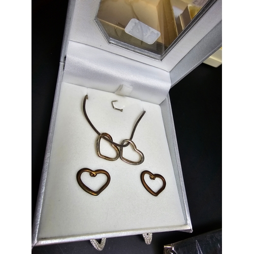 191 - A bundle of 925 silver earrings along with a silver plated heart jewellery set. All the earrings are... 