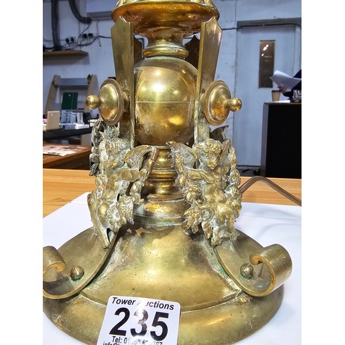 235 - A very heavy good quality french solid brass ornate lamp featuring an orb surrounded by 4 cherubs to... 