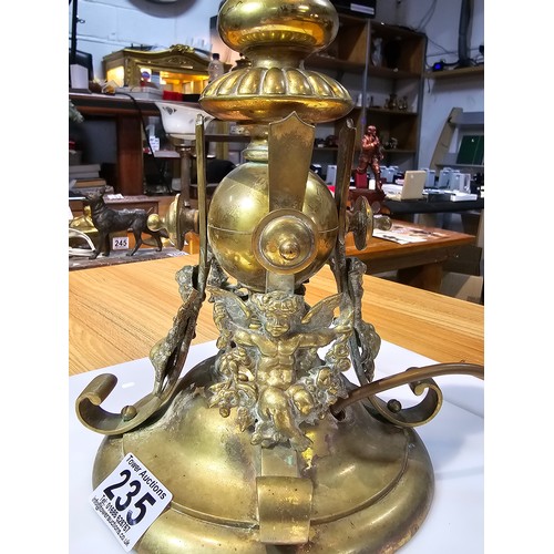 235 - A very heavy good quality french solid brass ornate lamp featuring an orb surrounded by 4 cherubs to... 