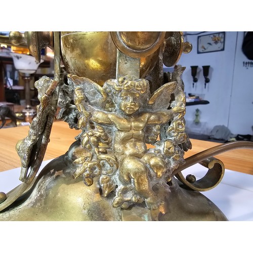 235 - A very heavy good quality french solid brass ornate lamp featuring an orb surrounded by 4 cherubs to... 