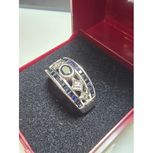 225 - A stunning hallmarked 9ct white gold dress ring inset with a large deep Royal blue sapphire stone to... 