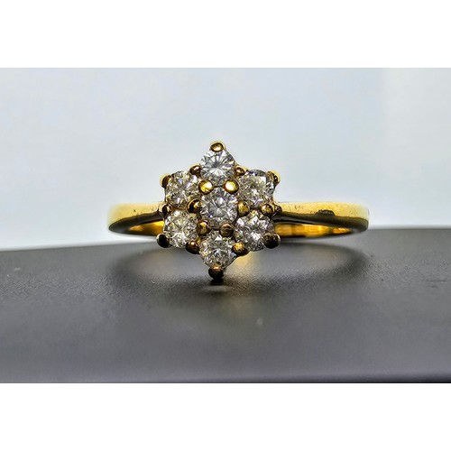 215 - A stunning hallmarked 9ct yellow gold diamond cluster ring inset with 7 round diamond stones which a... 