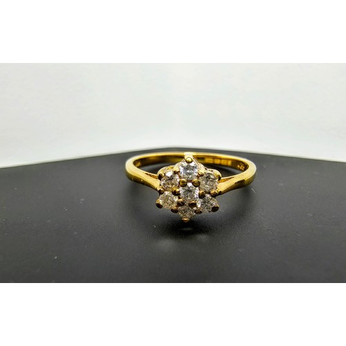 215 - A stunning hallmarked 9ct yellow gold diamond cluster ring inset with 7 round diamond stones which a... 