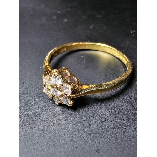 215 - A stunning hallmarked 9ct yellow gold diamond cluster ring inset with 7 round diamond stones which a... 