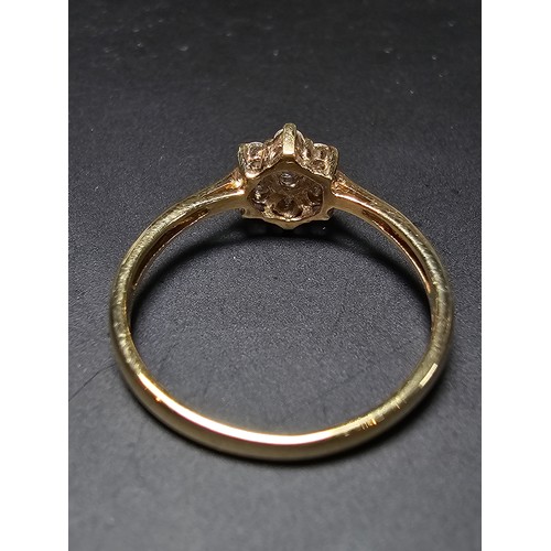 215 - A stunning hallmarked 9ct yellow gold diamond cluster ring inset with 7 round diamond stones which a... 