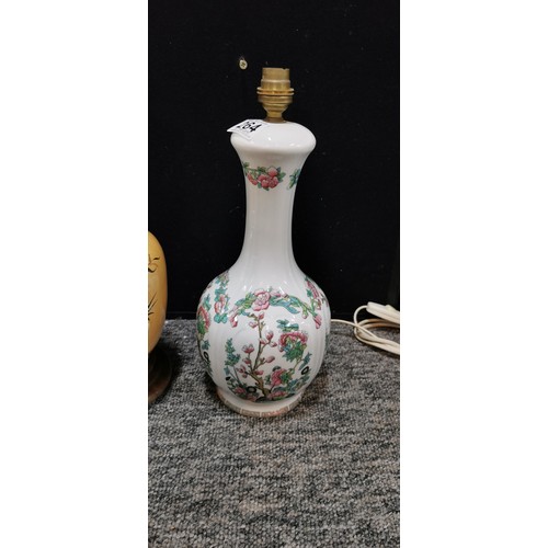 345 - An Indian tree ceramic lamp stand along with a beige coloured lamp. Largest lamp measures 39cm. Both... 