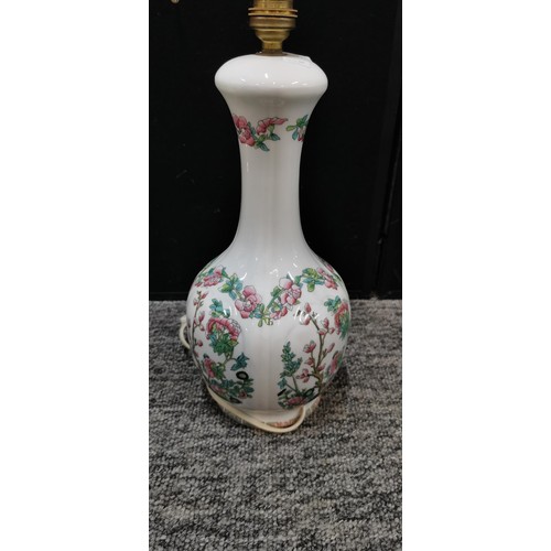 345 - An Indian tree ceramic lamp stand along with a beige coloured lamp. Largest lamp measures 39cm. Both... 