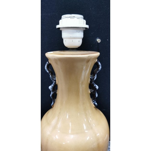 345 - An Indian tree ceramic lamp stand along with a beige coloured lamp. Largest lamp measures 39cm. Both... 