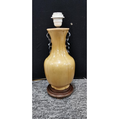 345 - An Indian tree ceramic lamp stand along with a beige coloured lamp. Largest lamp measures 39cm. Both... 