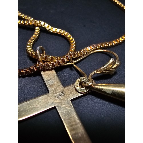 305 - A 9ct yellow gold cross pendant set on a very long gold plated 27