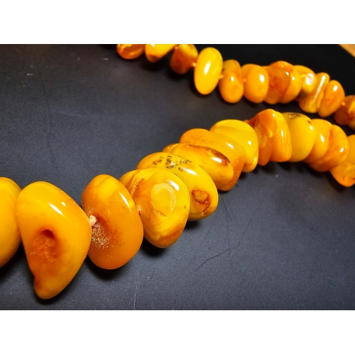 189 - A good quality vintage genuine butterscotch amber beaded necklace featuring polished shaped amber be... 