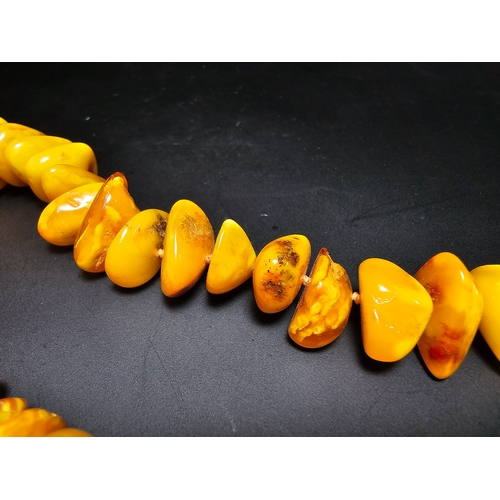 189 - A good quality vintage genuine butterscotch amber beaded necklace featuring polished shaped amber be... 